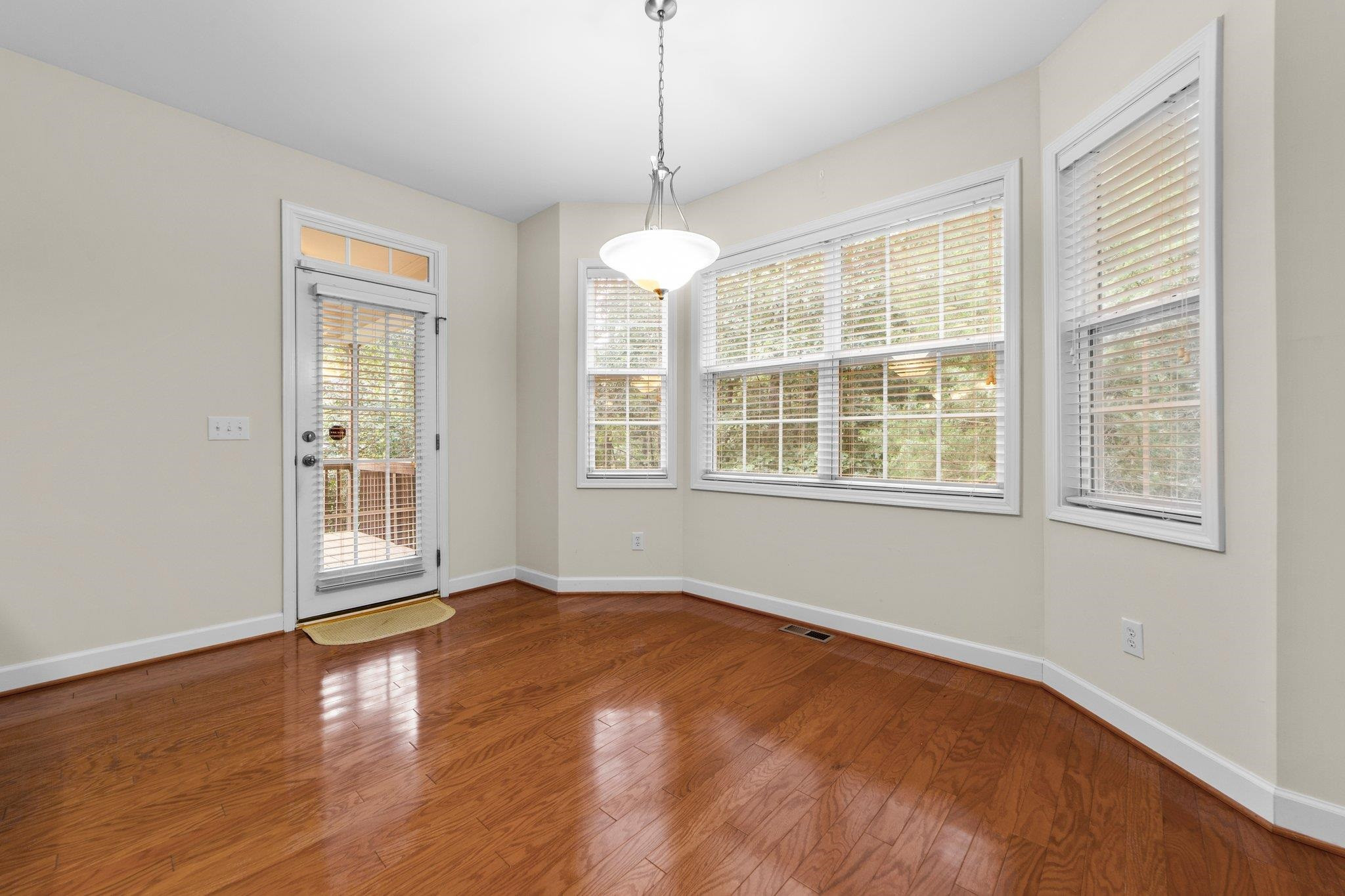 104 Harkness Circle Durham, NC 27705 - Photo 11 of 23 wooden floor in an empty room with a window