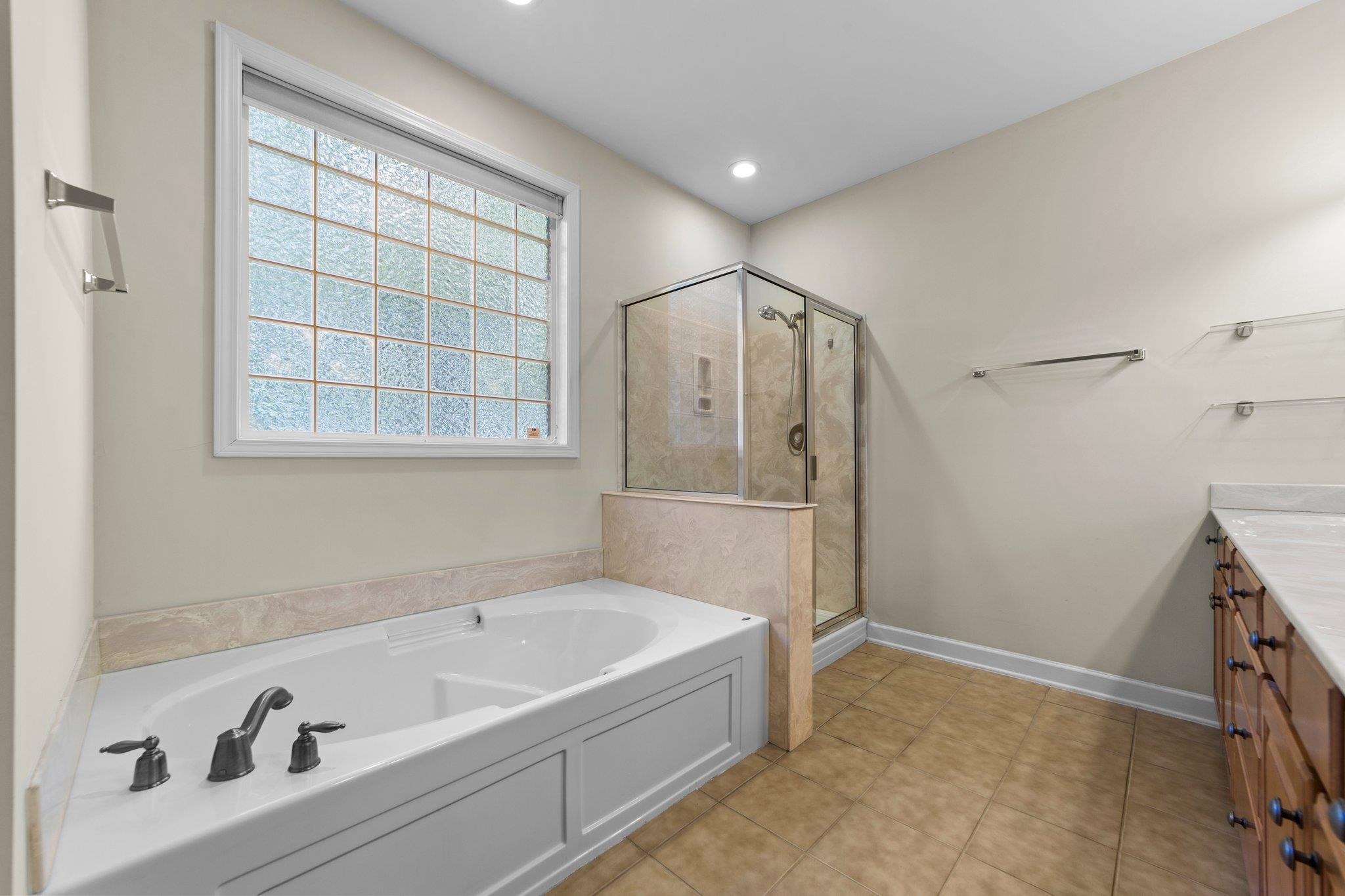 104 Harkness Circle Durham, NC 27705 - Photo 14 of 23 a bathroom with a tub a window and a shower