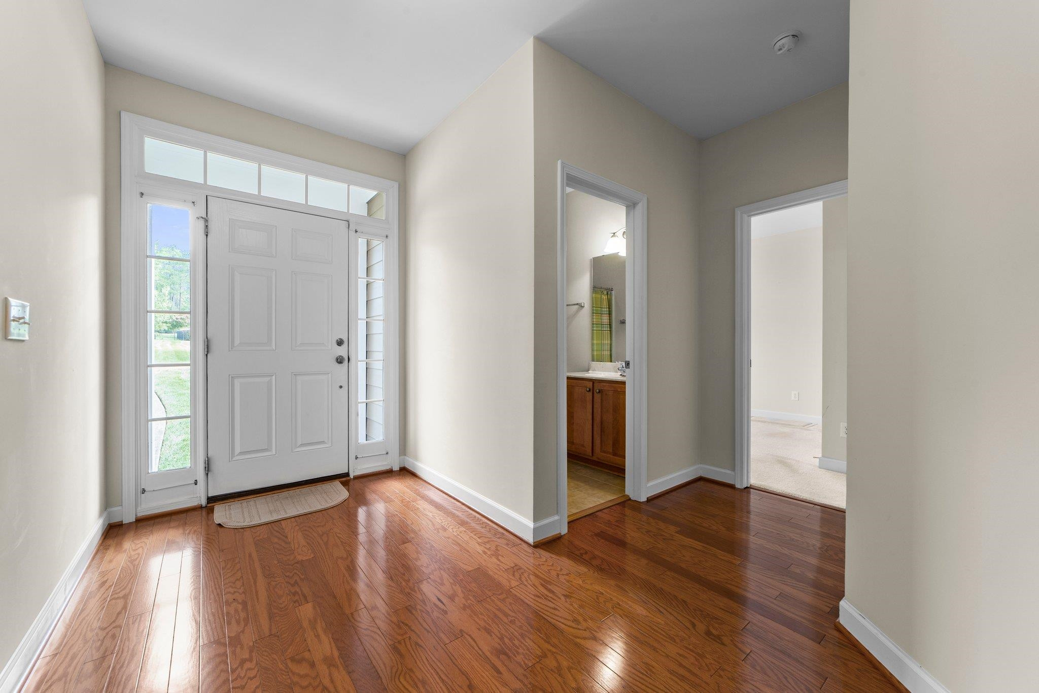 104 Harkness Circle Durham, NC 27705 - Photo 2 of 23 an empty room with wooden floor and windows