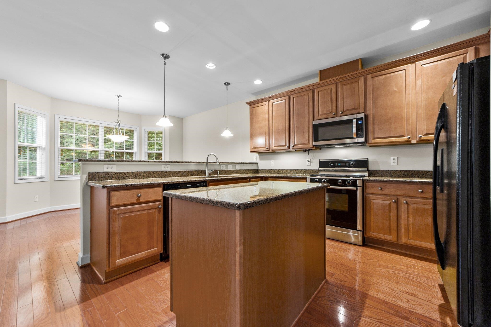 104 Harkness Circle Durham, NC 27705 - Photo 8 of 23 a kitchen with stainless steel appliances granite countertop a stove a sink and a refrigerator