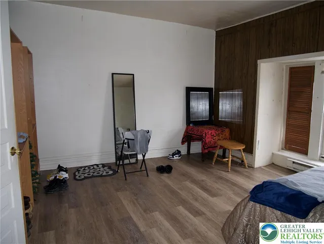 a view of a workspace with furniture and a mirror