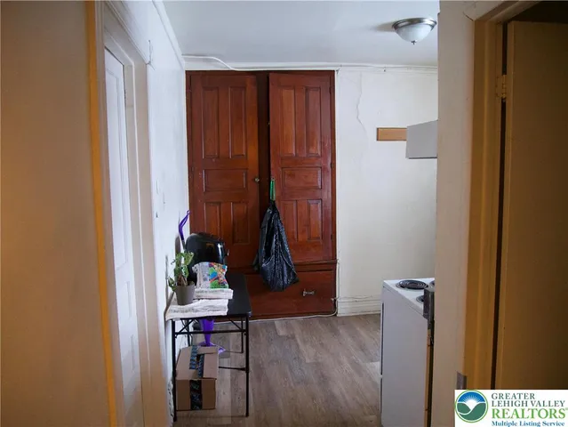 a room that has painting on the wall and a potted plant