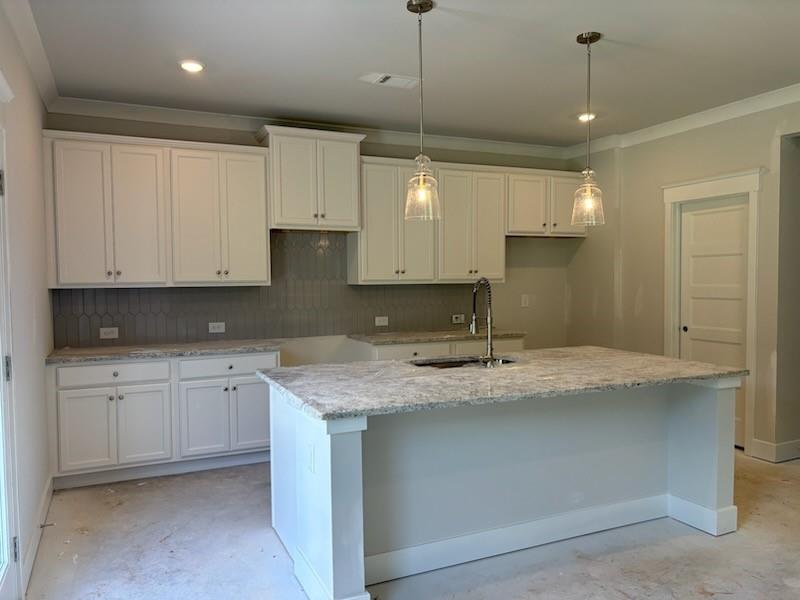 6 Commons Way Cartersville, GA 30120 - Photo 3 of 37 a kitchen with kitchen island granite countertop a sink cabinets and stainless steel appliances