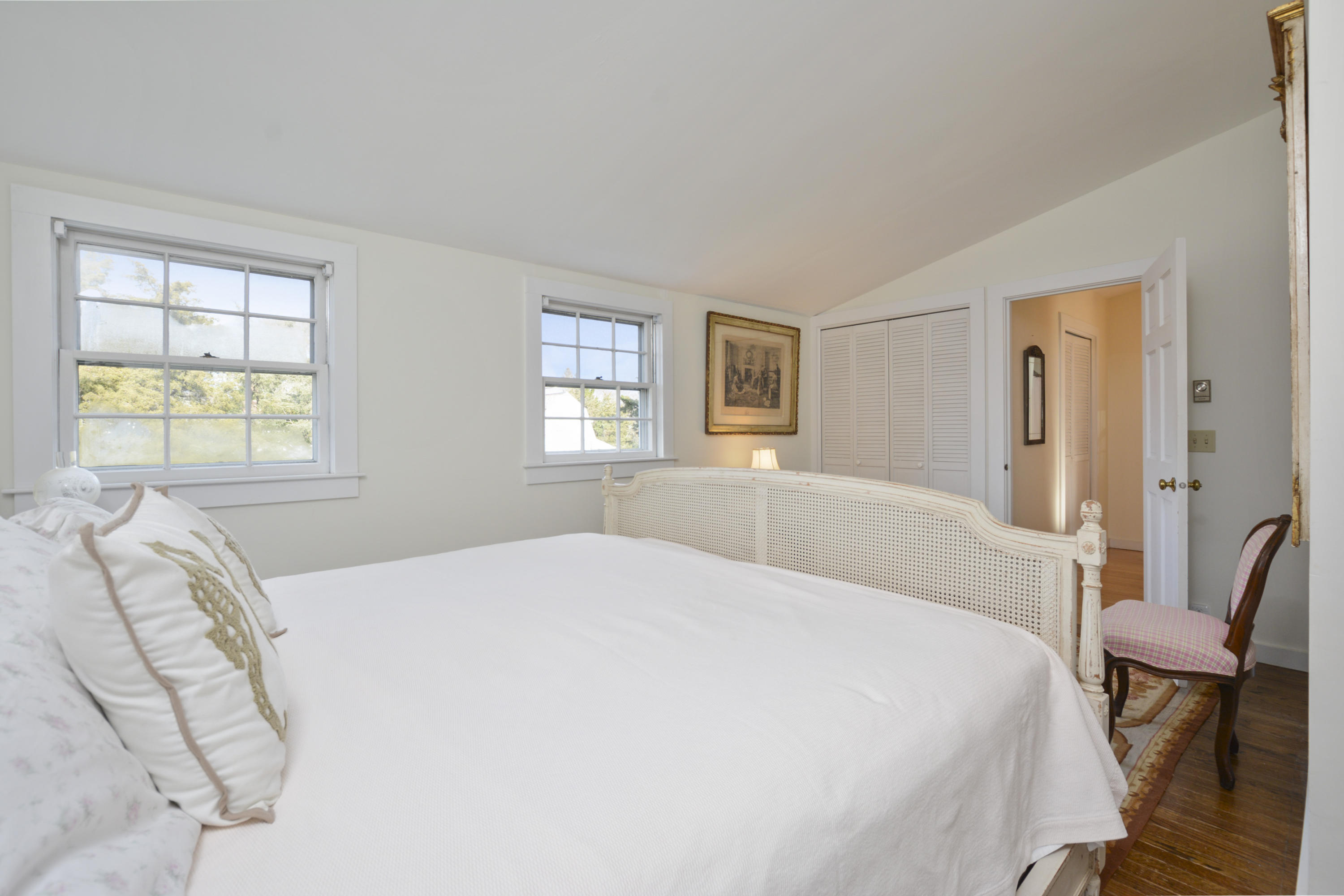 18 Peaks Drive Osterville, MA 02655 - Photo 21 of 40 a spacious bedroom with a bed a couch and windows