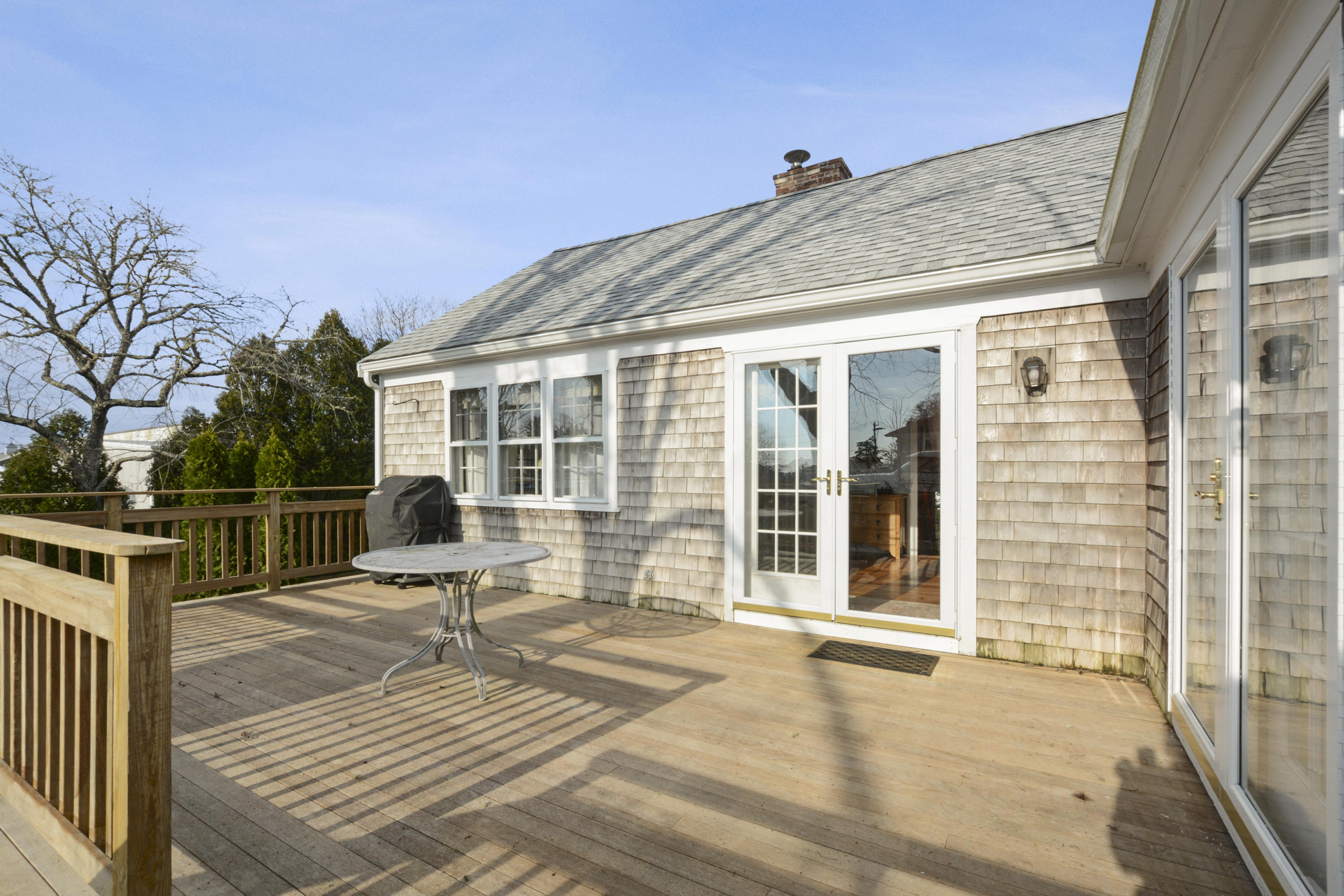 18 Peaks Drive Osterville, MA 02655 - Photo 31 of 40 a roof deck with table and chairs and wooden floor