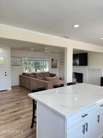 a kitchen with a sink a microwave and cabinets