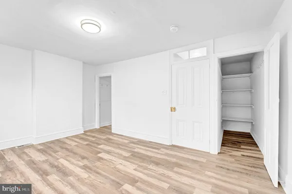 a view of a room with wooden floor and white doors