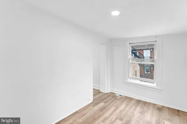 an empty room with windows and closet