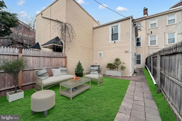 a view of a patio with couches chairs and a fire pit