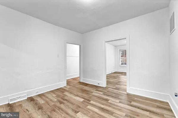 a view of an empty room and wooden floor