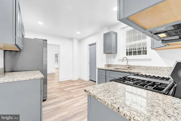 a kitchen with a stove and a refrigerator