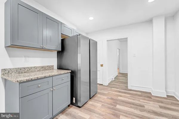 a kitchen with a refrigerator and cabinets