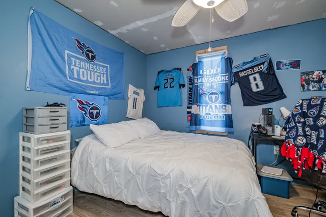 a bedroom with a bed a dresser and a walk in closet