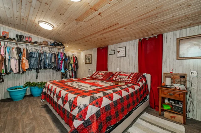 a bedroom with a bed and a flat screen tv