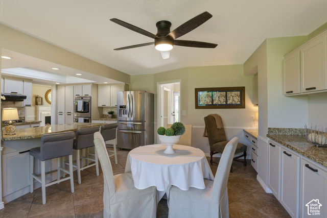 1933 Rua Branco Drive Sandy, UT 84093 - Photo 14 of 42 Open-concept kitchen with recessed lighting, fan, stainless steel appliances, and a breakfast bar