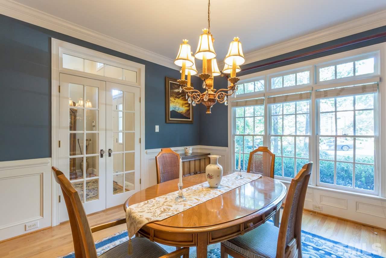 4625 Gamelyn Walk Raleigh, NC 27612 - Photo 2 of 25 a dining room with furniture a chandelier and wooden floor
