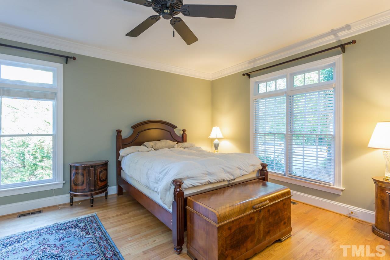 4625 Gamelyn Walk Raleigh, NC 27612 - Photo 11 of 25 a bedroom with a bed and wooden floor