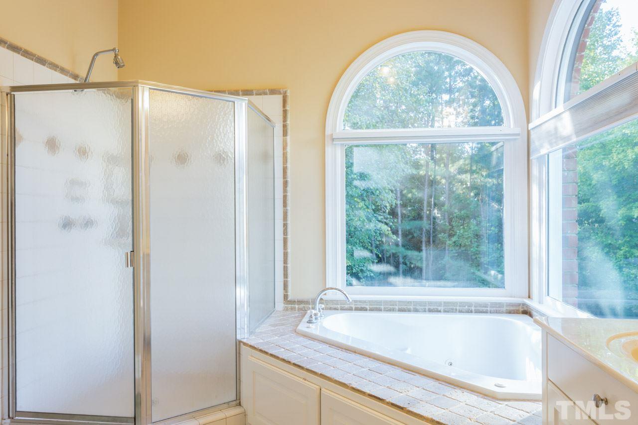 4625 Gamelyn Walk Raleigh, NC 27612 - Photo 13 of 25 a bathroom with a shower and a bathtub