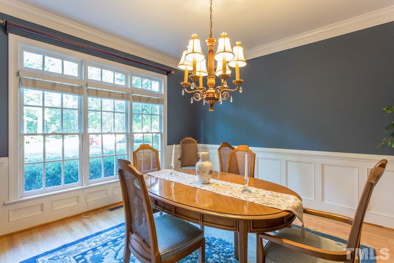 4625 Gamelyn Walk Raleigh, NC 27612 - Photo 3 of 25 a dining room table with chair and chandelier