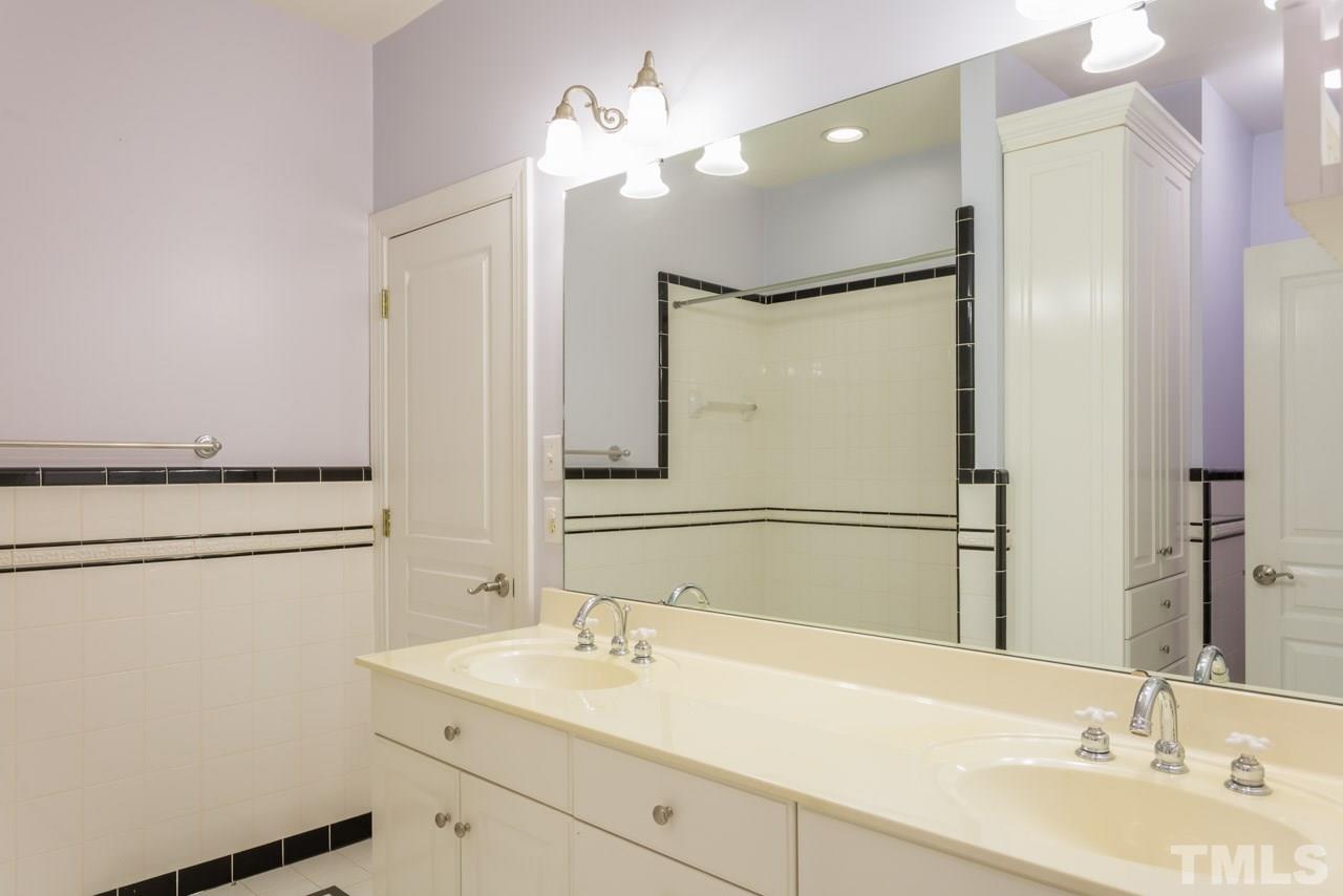 4625 Gamelyn Walk Raleigh, NC 27612 - Photo 21 of 25 a bathroom with a sink vanity granite and a mirror
