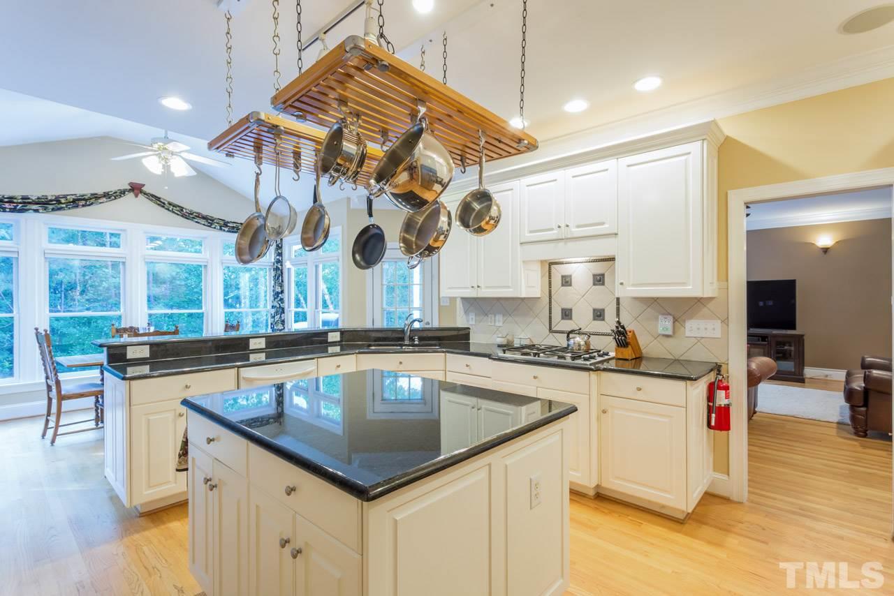 4625 Gamelyn Walk Raleigh, NC 27612 - Photo 6 of 25 a kitchen with a sink a counter space appliances and cabinets
