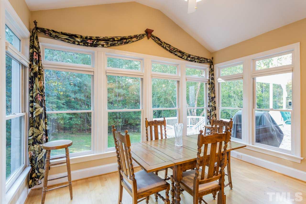 4625 Gamelyn Walk Raleigh, NC 27612 - Photo 8 of 25 a view of a dining room with furniture large windows and wooden floor