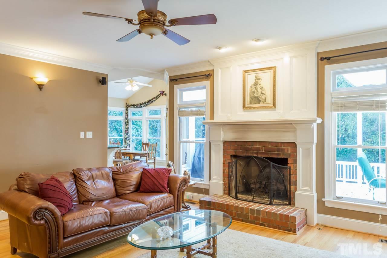 4625 Gamelyn Walk Raleigh, NC 27612 - Photo 10 of 25 a living room with furniture a fireplace and a large window