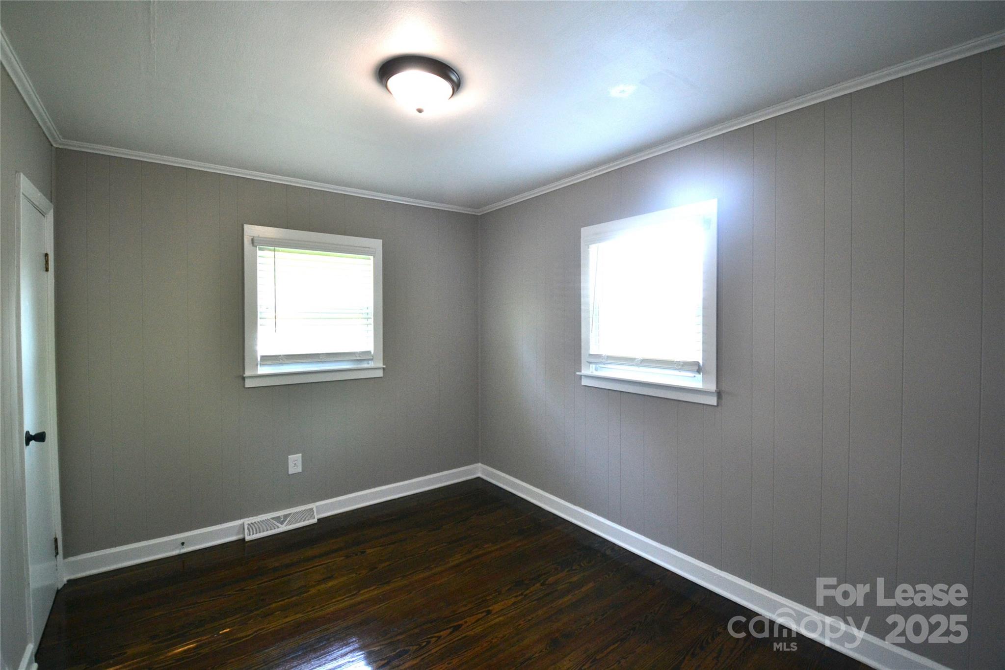 222 Ewing Drive Belmont, NC 28012 - Photo 23 of 31 an empty room with wooden floor and windows