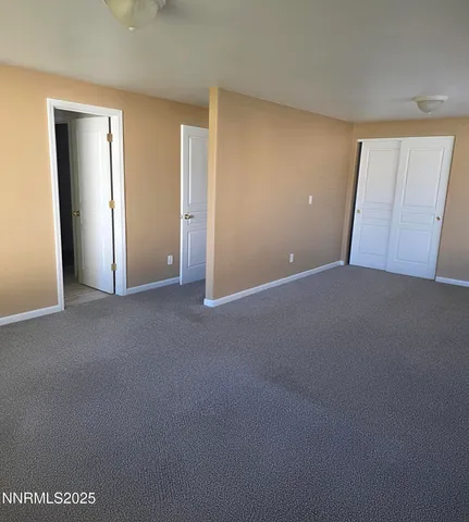 a view of an empty room and closet area