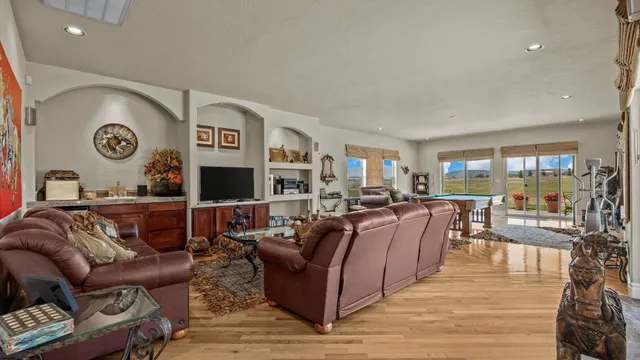 a living room with furniture and a wooden floor