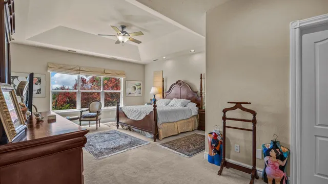 a bedroom with furniture and a mirror