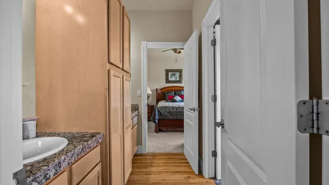 a en suite bathroom with a granite countertop sink and a shower
