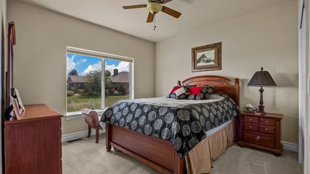 a bedroom with a bed and a chandelier