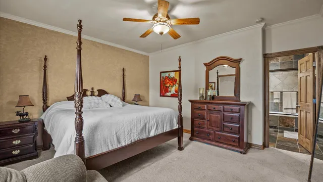 a bedroom with a bed and a chandelier