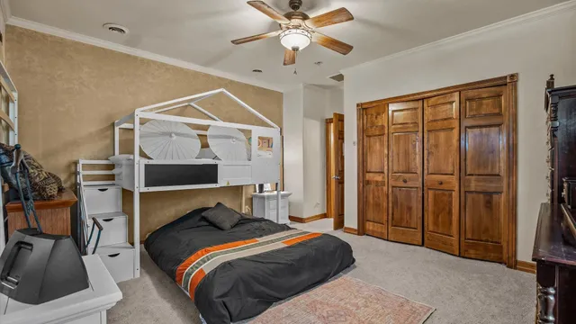 a bedroom with a bed and a chandelier