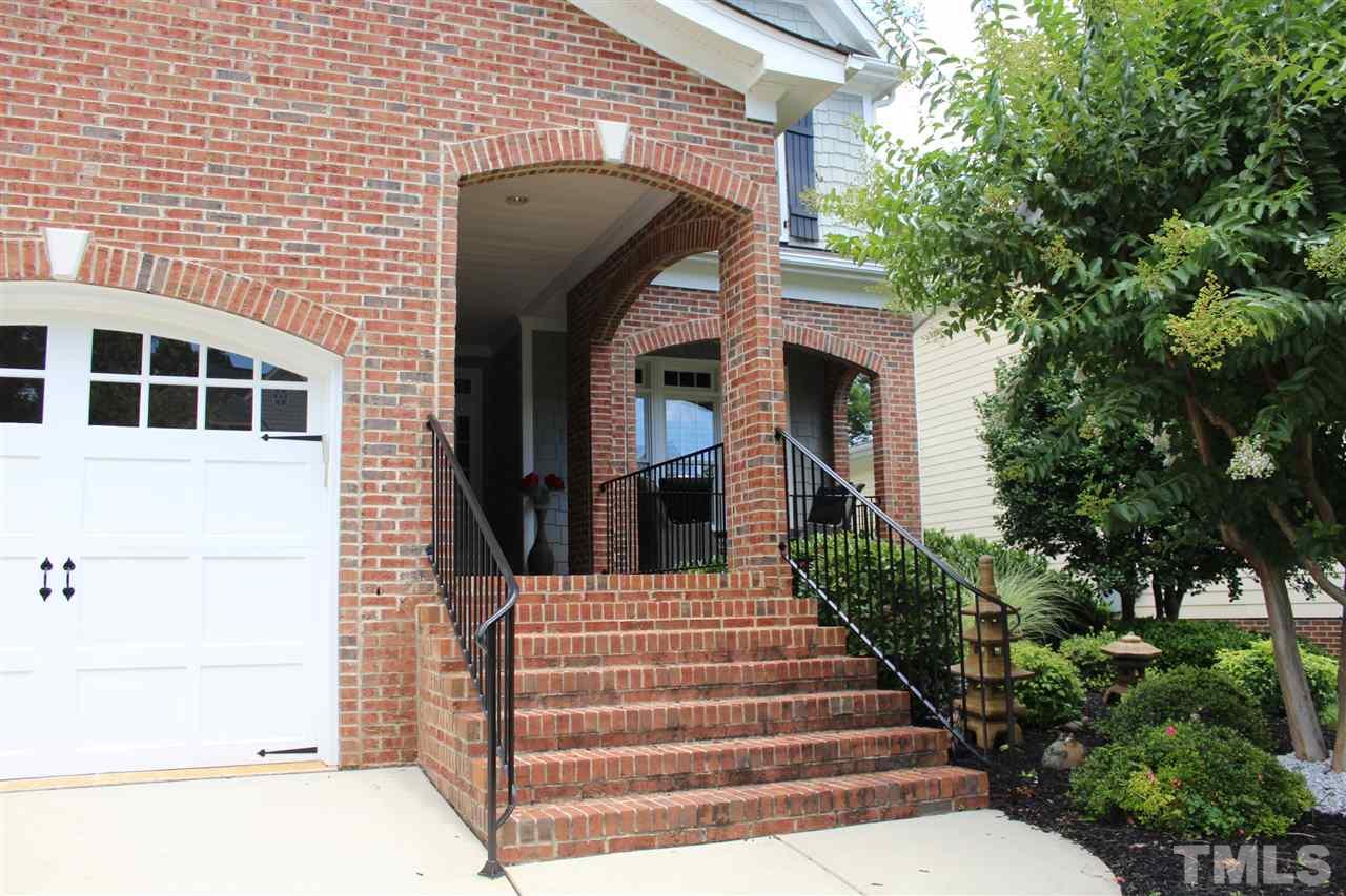 12336 Beestone Lane Raleigh, NC 27614 - Photo 2 of 21 a view of a brick house with large windows and a small yard