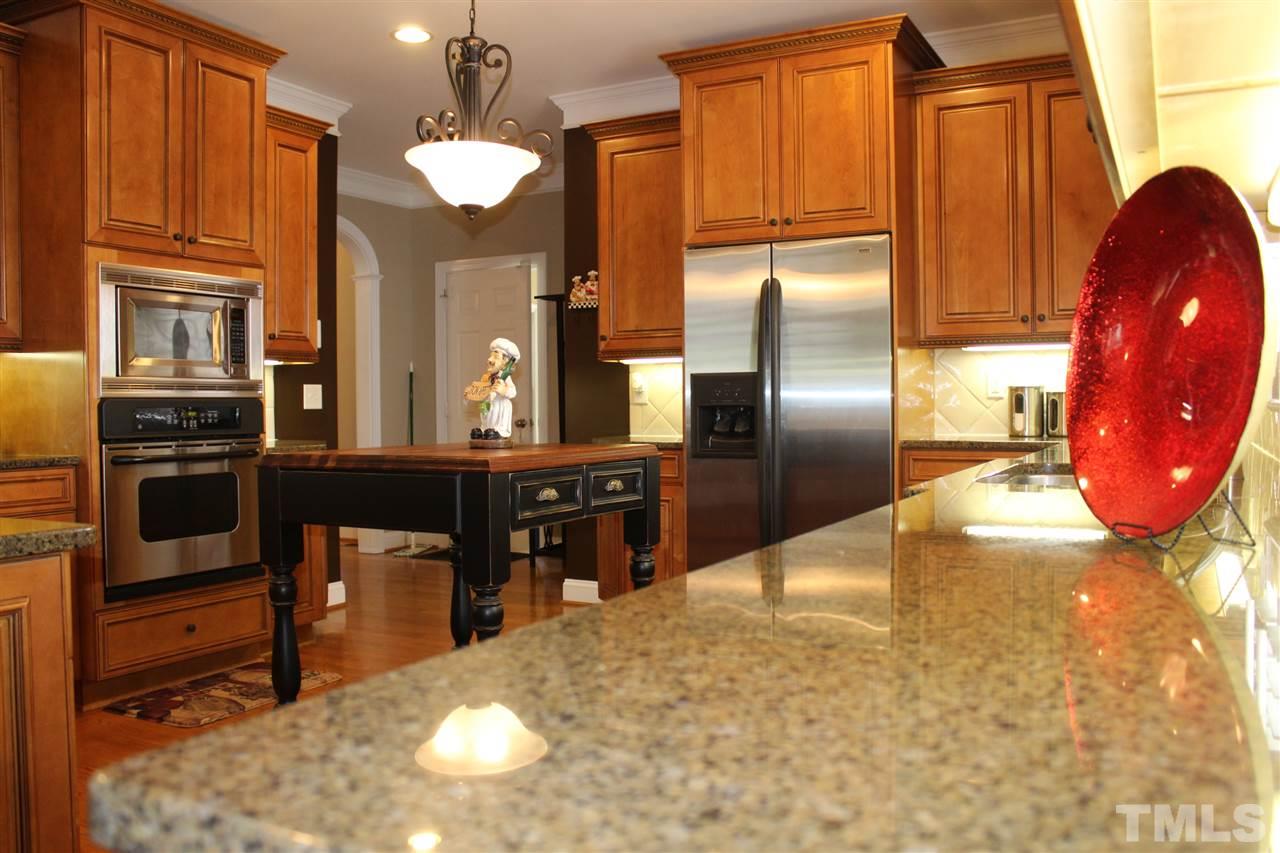 12336 Beestone Lane Raleigh, NC 27614 - Photo 11 of 21 a kitchen with granite countertop a refrigerator cabinets and stove