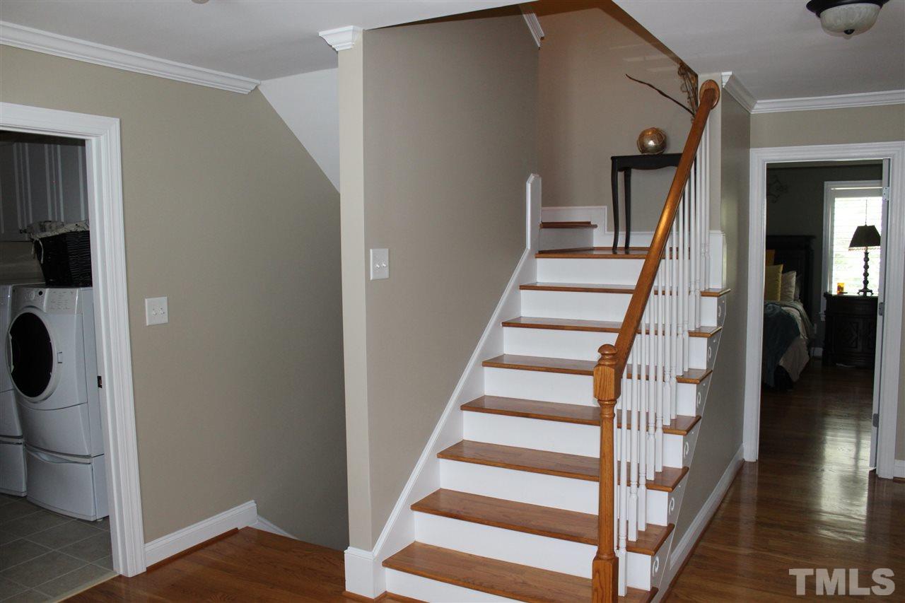 12336 Beestone Lane Raleigh, NC 27614 - Photo 16 of 21 a view of entryway with wooden floor and stairs