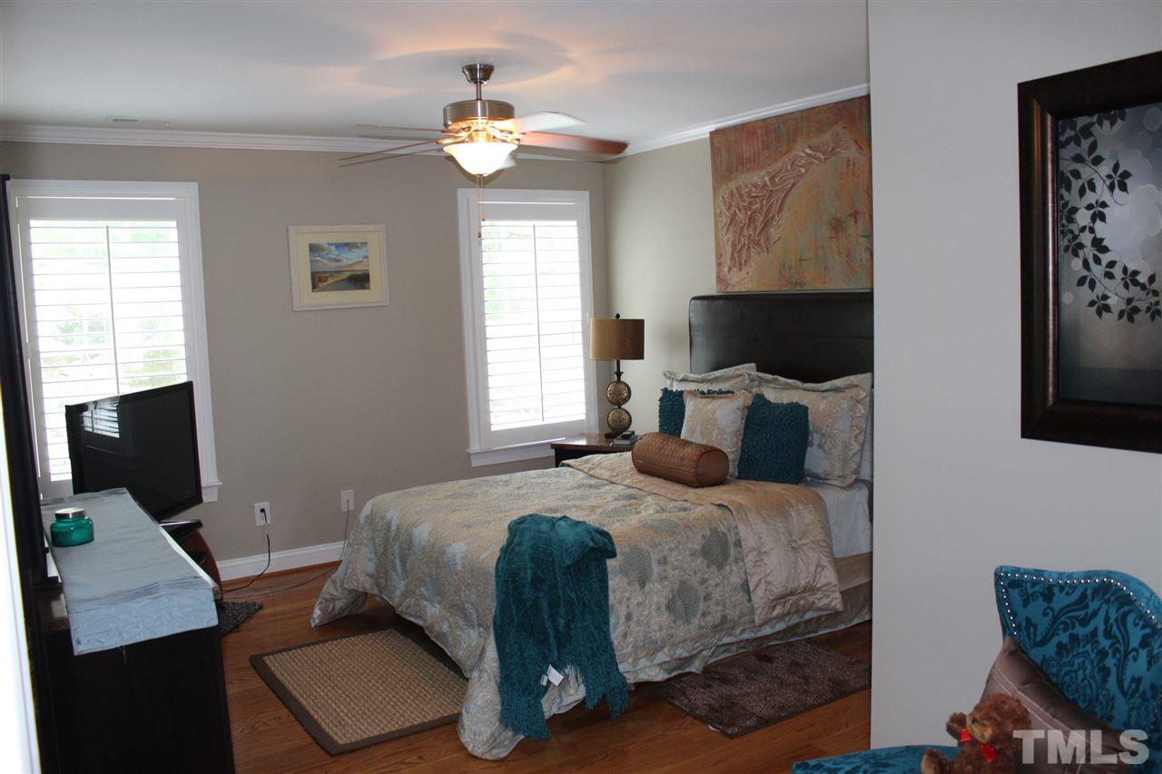 12336 Beestone Lane Raleigh, NC 27614 - Photo 19 of 21 a bedroom with a bed window and a flat screen tv
