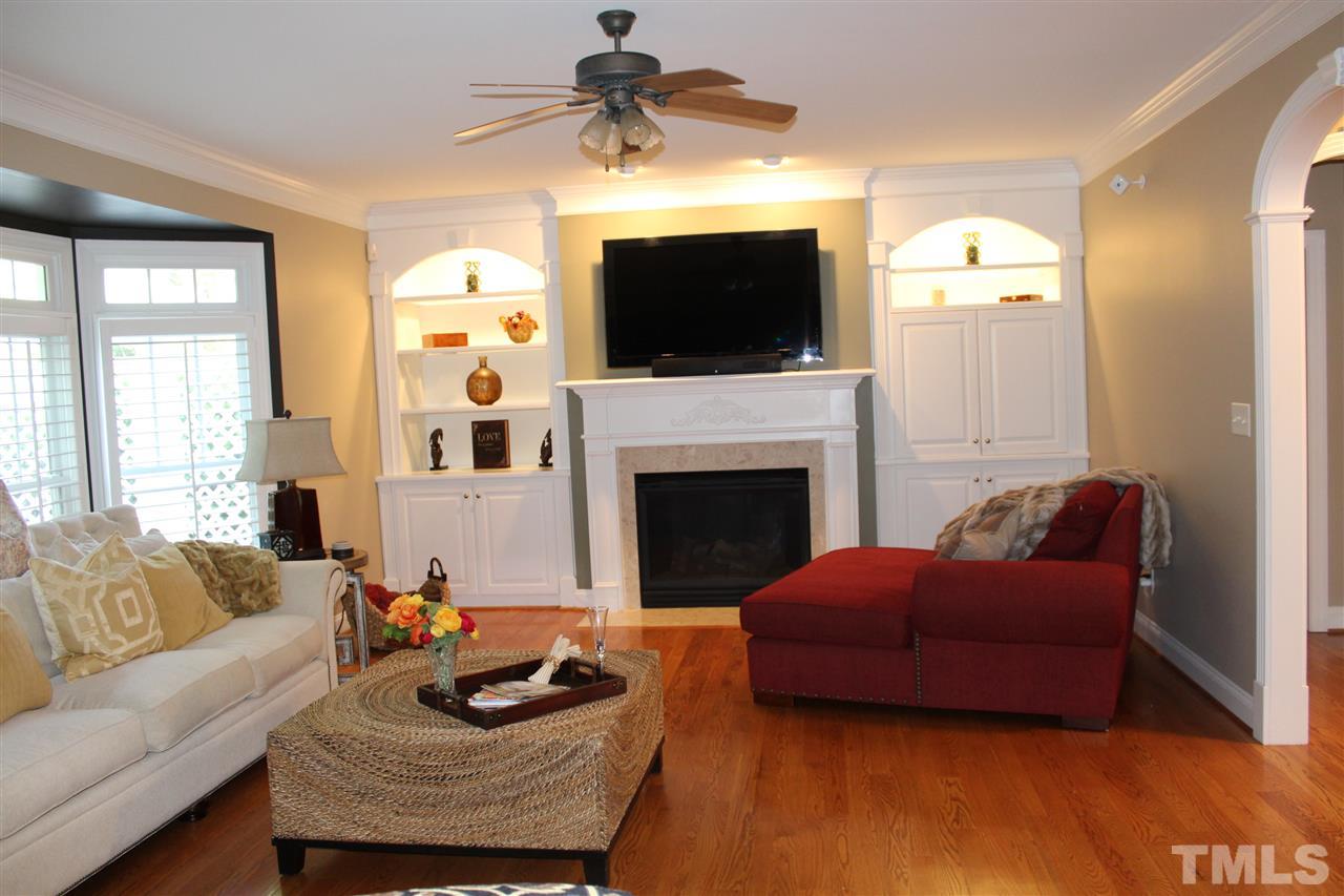 12336 Beestone Lane Raleigh, NC 27614 - Photo 6 of 21 a living room with furniture a flat screen tv and a fireplace