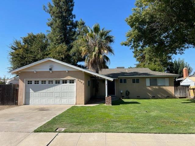 a front view of a house with a garden and yard