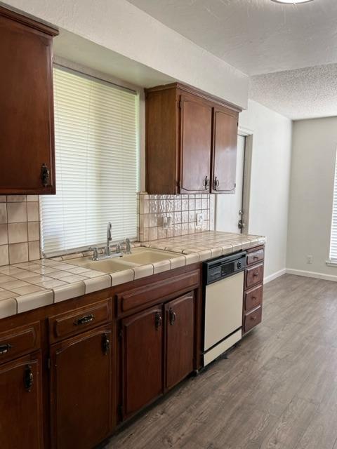 2898 Adler Avenue Clovis, CA 93612 - Photo 6 of 12 a kitchen with a sink and a wooden cabinets