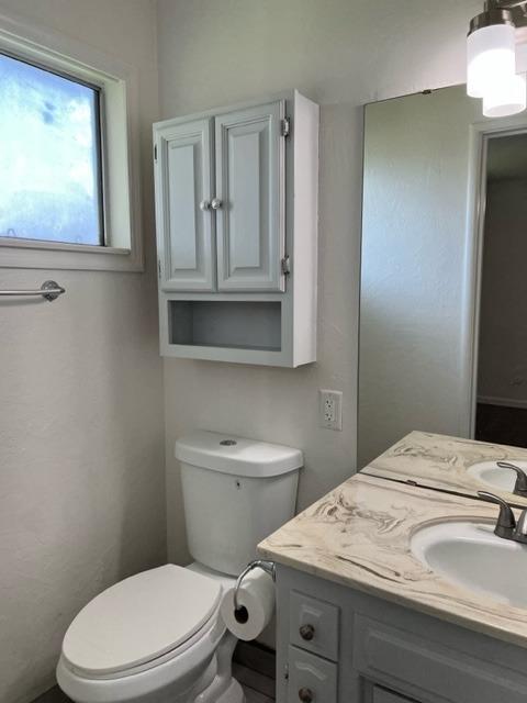 2898 Adler Avenue Clovis, CA 93612 - Photo 8 of 12 a bathroom with a toilet a sink and mirror