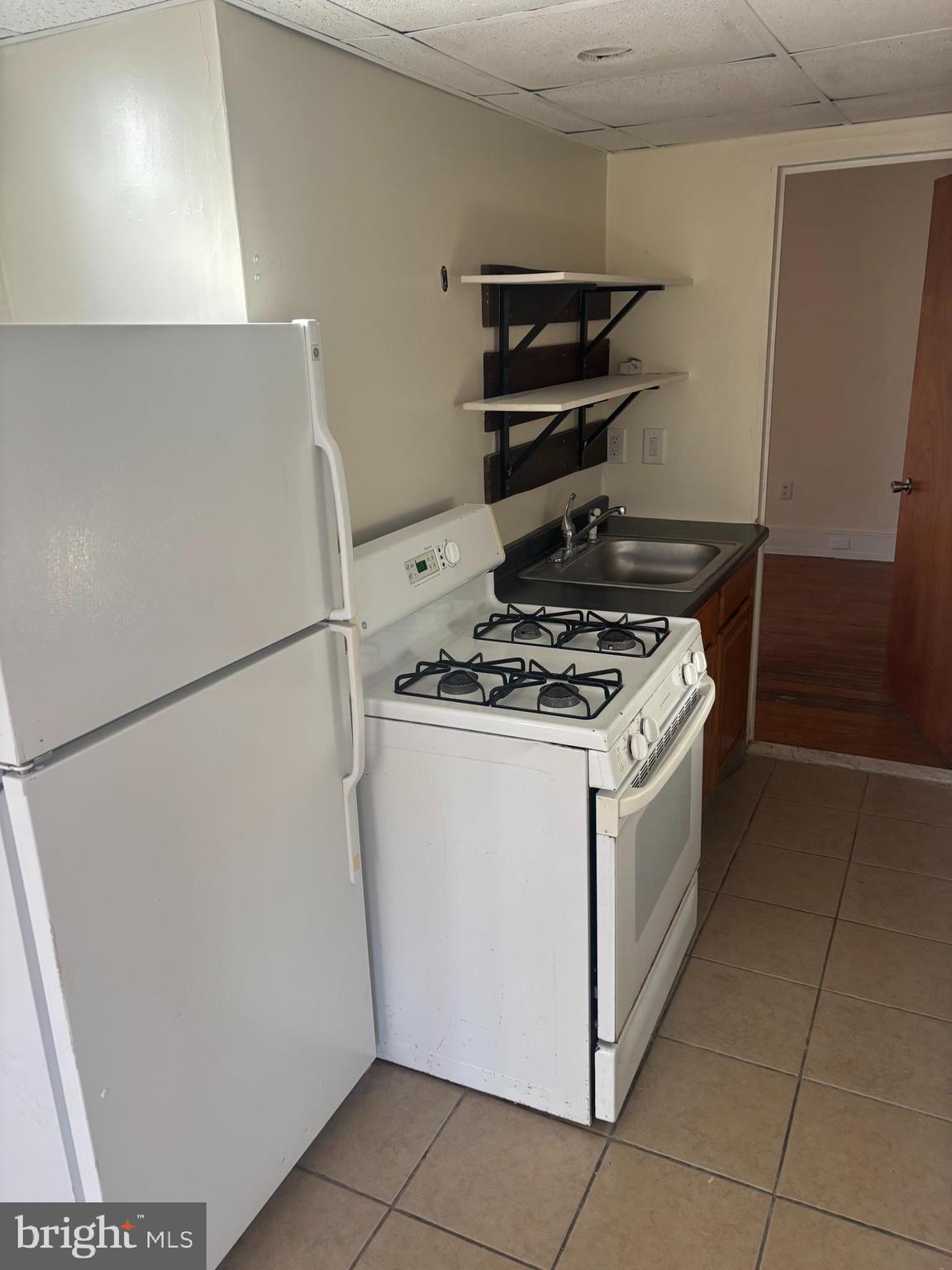 4715 Springfield Avenue, Unit 2F Philadelphia, PA 19143 - Photo 3 of 6 a kitchen with a stove and a refrigerator