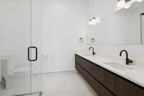 a bathroom that has a glass shower door