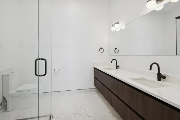 a bathroom that has a glass shower door
