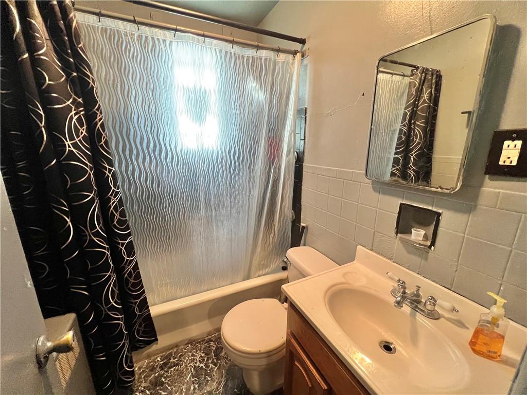 806 Inwood Street Pittsburgh, PA 15208 - Photo 13 of 17 a bathroom with a sink and mirror with toilet