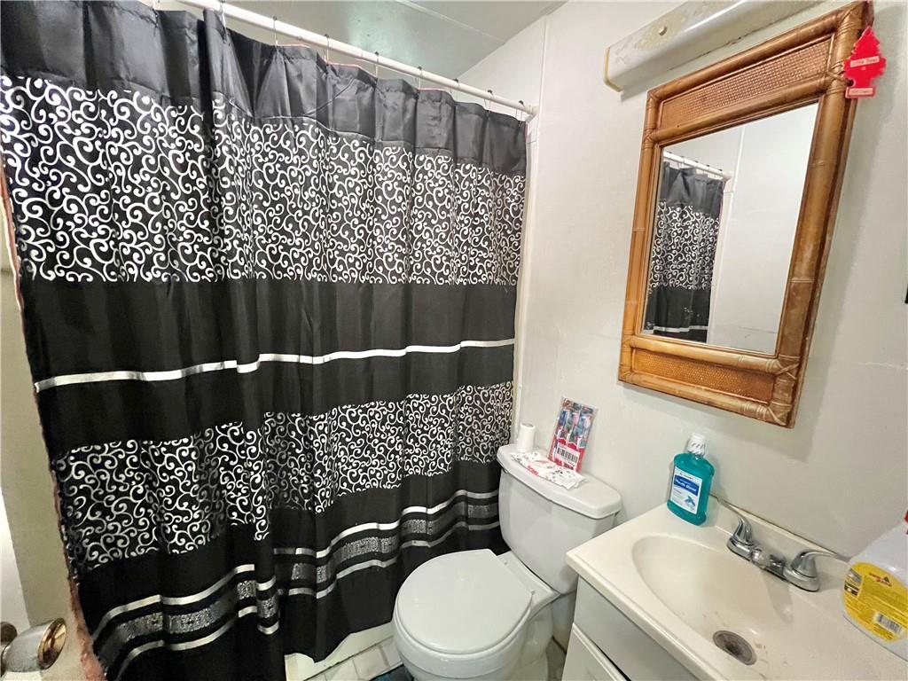 806 Inwood Street Pittsburgh, PA 15208 - Photo 8 of 17 a bathroom with a sink a toilet and a mirror