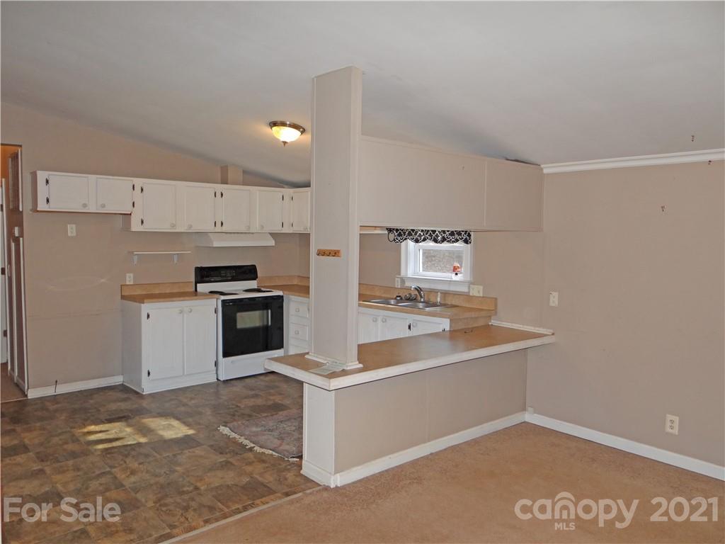 4053 Chevlot Hills Road Sherrills Ford, NC 28673 - Photo 14 of 22 a large white kitchen with a sink and stainless steel appliances