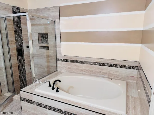 a bathroom with a tub and a sink